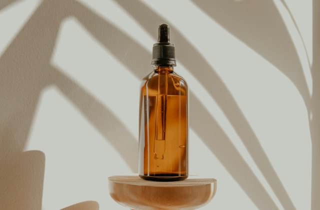 An amber glass bottle with a dropper